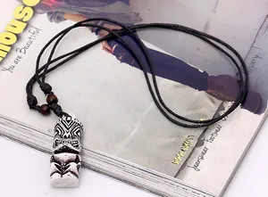 Detail of tribal tiki pendant necklace with black wax cord and wooden beads