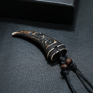 Tribal wolf tooth resin pendant necklace with black cord and brown wooden beads