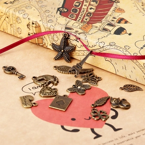 Mix of antique bronze DIY charms featuring Eiffel Tower, heart, and leaf shapes