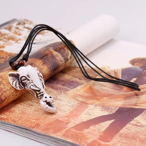 Vintage elephant head pendant necklace with white textured resin and black woven cord