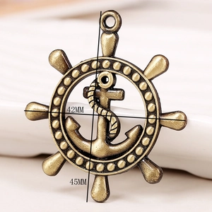 Macro detail of antique bronze anchor and helm pendant showing 42mm x 45mm dimensions