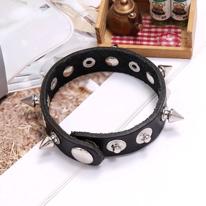 Detail view of black leather punk bracelet with silver metal spikes and rivet studs