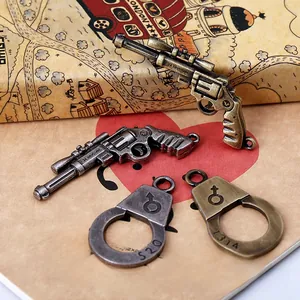 Macro detail of antique bronze and silver punk style pistol and handcuff charms