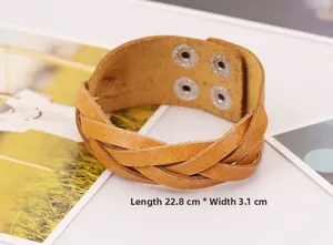 Detailed view of brown woven leather bracelet with metal snaps, size 22.8cm by 3.1cm