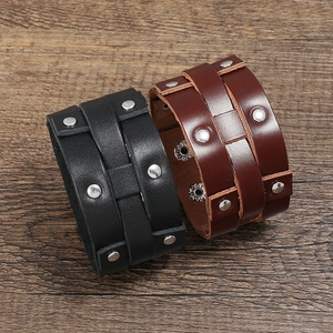 Punk style wide leather bracelets for men in black and brown with metal rivets