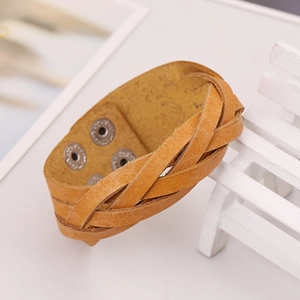 Brown braided leather multilayer bracelet with adjustable metal snap buttons on white wood