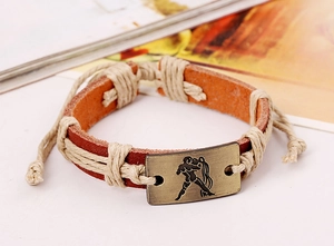 Detail view of woven leather bracelet with bronze Aquarius constellation metal plate