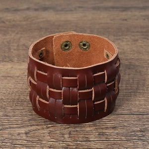 Detail of multi-layer woven vintage leather bracelet with antique brass snap buttons