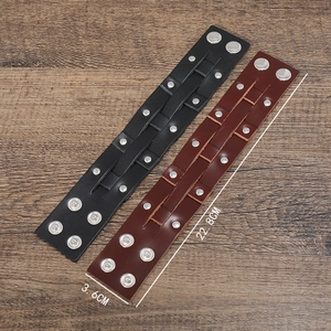 Detail view of 22.8cm punk leather wristbands in black and brown with metal rivets