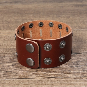 Detail view of double-row rivets on vintage brown cowhide leather biker bracelet