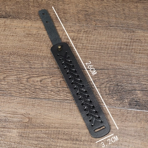 Detail view of woven black leather bracelet with dimensions of 26cm length and 3.2cm width