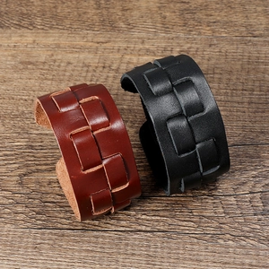 Men's punk multilayer woven leather bracelet in brown and black on a wooden background