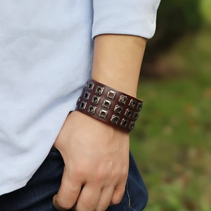 Close-up of vintage three-row square stud punk leather bracelet on model's wrist