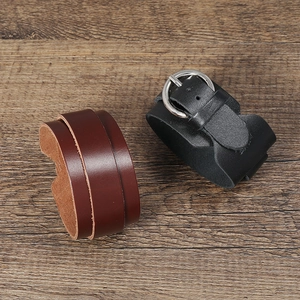 Minimalist double-wrap leather bracelet in black and brown with metal buckles on wood