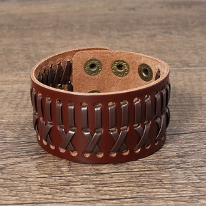 Close-up of vintage brown braided leather bracelet with adjustable metal snap buttons