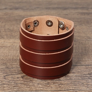Detail view of multi-layer retro brown leather punk bracelet with adjustable metal snaps