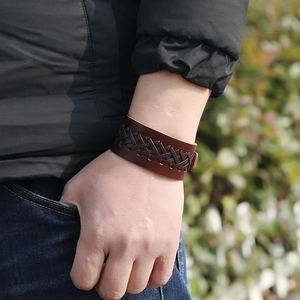 Close-up of vintage brown braided leather bracelet with woven texture on man wrist