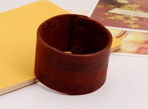 Detail of vintage brown leather punk bracelet with adjustable metal snap buttons