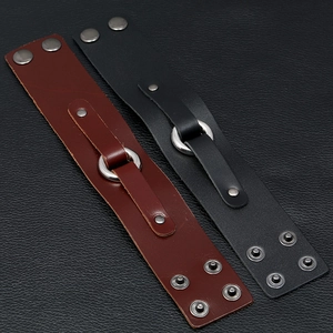 Close-up of vintage punk leather bracelets with metal ring and adjustable snaps