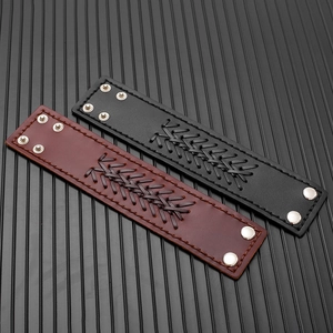 Detail of vintage men's wide leather bracelet with braided strips and metal snap buttons