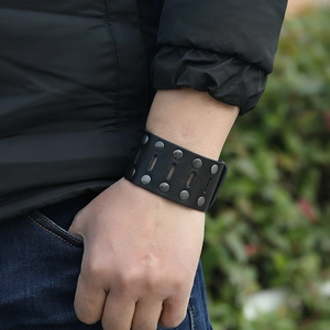 Punk style black leather wide bracelet with double row metal rivets on male wrist