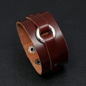 Detail of vintage punk dark brown wide leather bracelet with silver metal rings