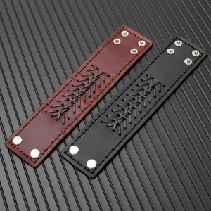 Detail of vintage braided leather bracelets with silver snap buttons in black and brown
