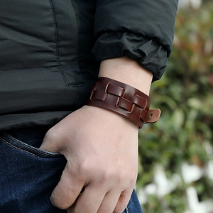 Detail of dark brown layered braided leather bracelet for men in punk and rock style