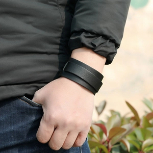 Outdoor shot of a man wearing a double-layer wide black leather cuff bracelet
