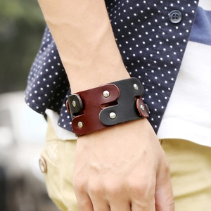 Vintage leather punk bracelet with silver metal rivets on a dual-tone black and brown strap