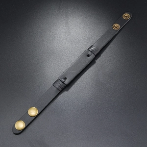 Detail view of black vintage leather bracelet with double brass adjustable buckles