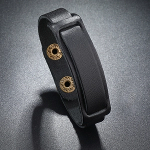 Macro detail of black vintage leather bracelet with bronze geometric rivets