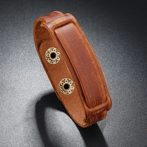Detailed view of heavy-duty brown genuine leather bracelet with vintage metal eyelets