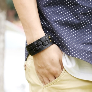 Men's multilayer black braided leather bracelet with vintage rivets on a model's wrist