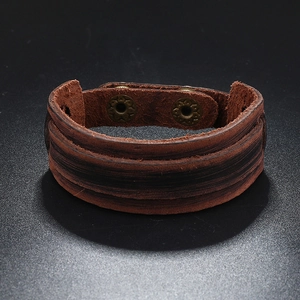 Detail of vintage brown leather woven bracelet with adjustable antique bronze snap buttons