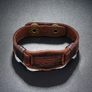 Close-up of vintage brown leather bracelet for men with adjustable metal snap buttons