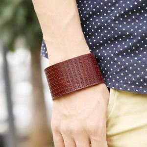 Vintage wide brown leather cuff bracelet for men featuring embossed X pattern details