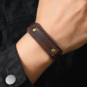 Vintage dark brown leather bracelet for men featuring brass studs and contrast stitching