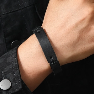 Detail of adjustable black multilayer leather bracelet on wrist with minimalist design
