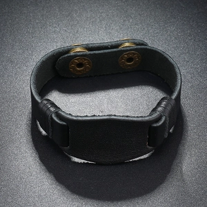 Macro shot of black wide leather bracelet with vintage bronze double snap buttons