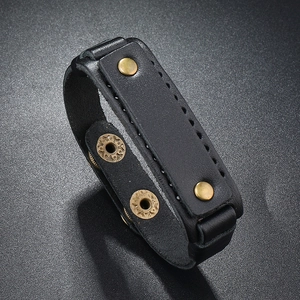 Detail of black leather punk bracelet with bronze metal snaps and textured stitching