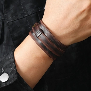 Macro shot of multi-layer brown leather bracelet with vintage bronze snap button