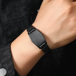 Close-up of black braided leather bracelet with natural litchi texture on male wrist