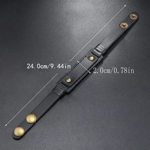 Retro black leather bracelet with bronze snaps shown in full length on dark grey surface