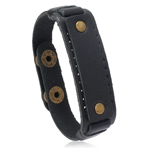 Minimalist black leather wristband with brass studs and adjustable snap fasteners