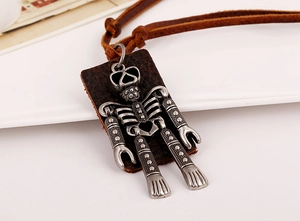 Macro shot of vintage robot pendant with silver metal structure and brown leather backing
