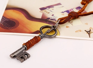 Detailed macro view of vintage lightning key pendant with 1983 engraving and leather cord