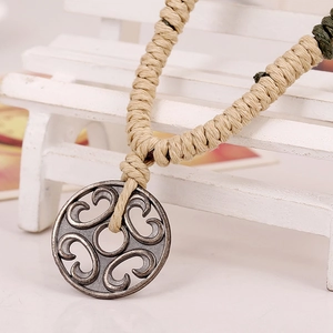 Retro hollow cloud pendant necklace with beige braided cord and green knot accents