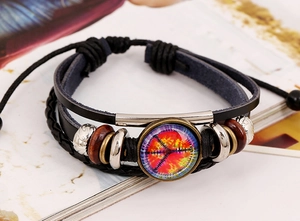 Detail of bohemian layered leather bracelet with peace sign charm and colorful beadwork