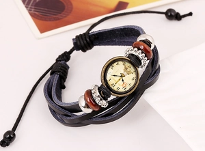 Macro view of multi-layer leather bracelet featuring vintage watch dial and metal gears